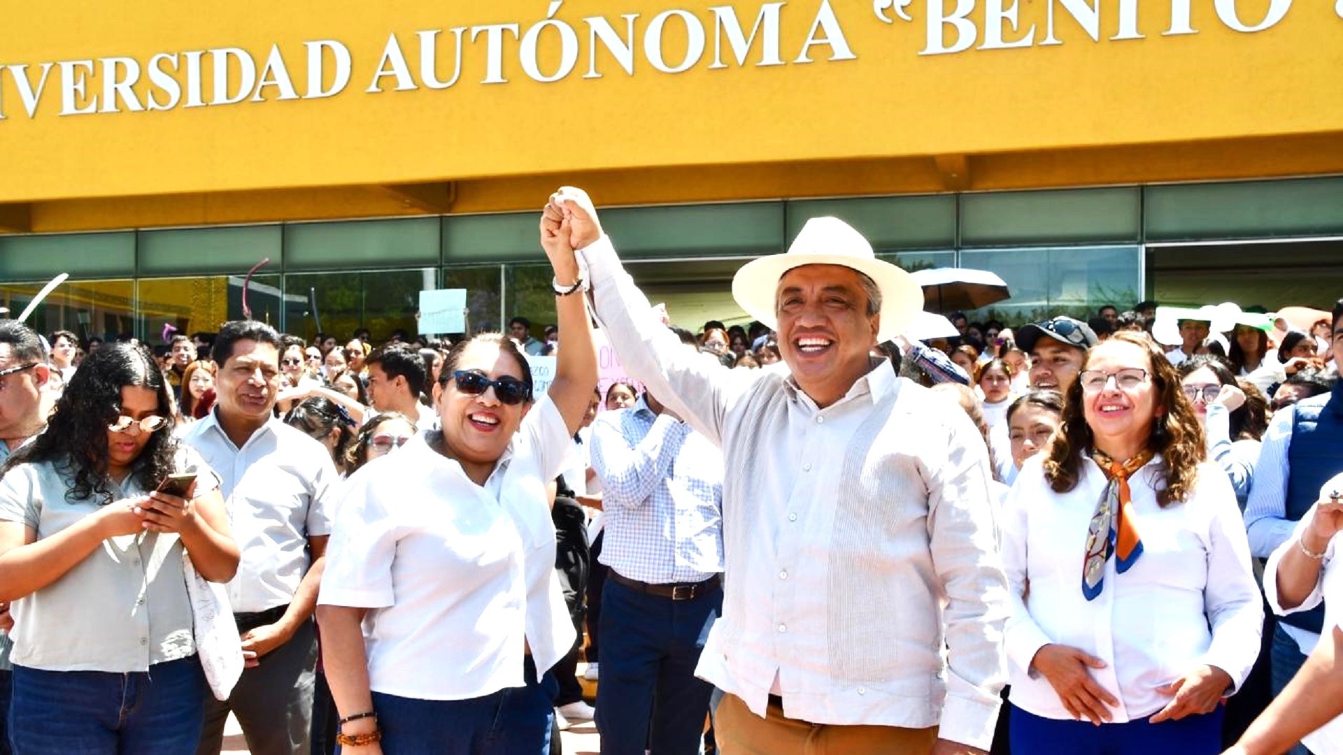 Amilcar Sosa, con camisa y sobrero blanco, rodeado de la comunidad universitaria de la UABJO.