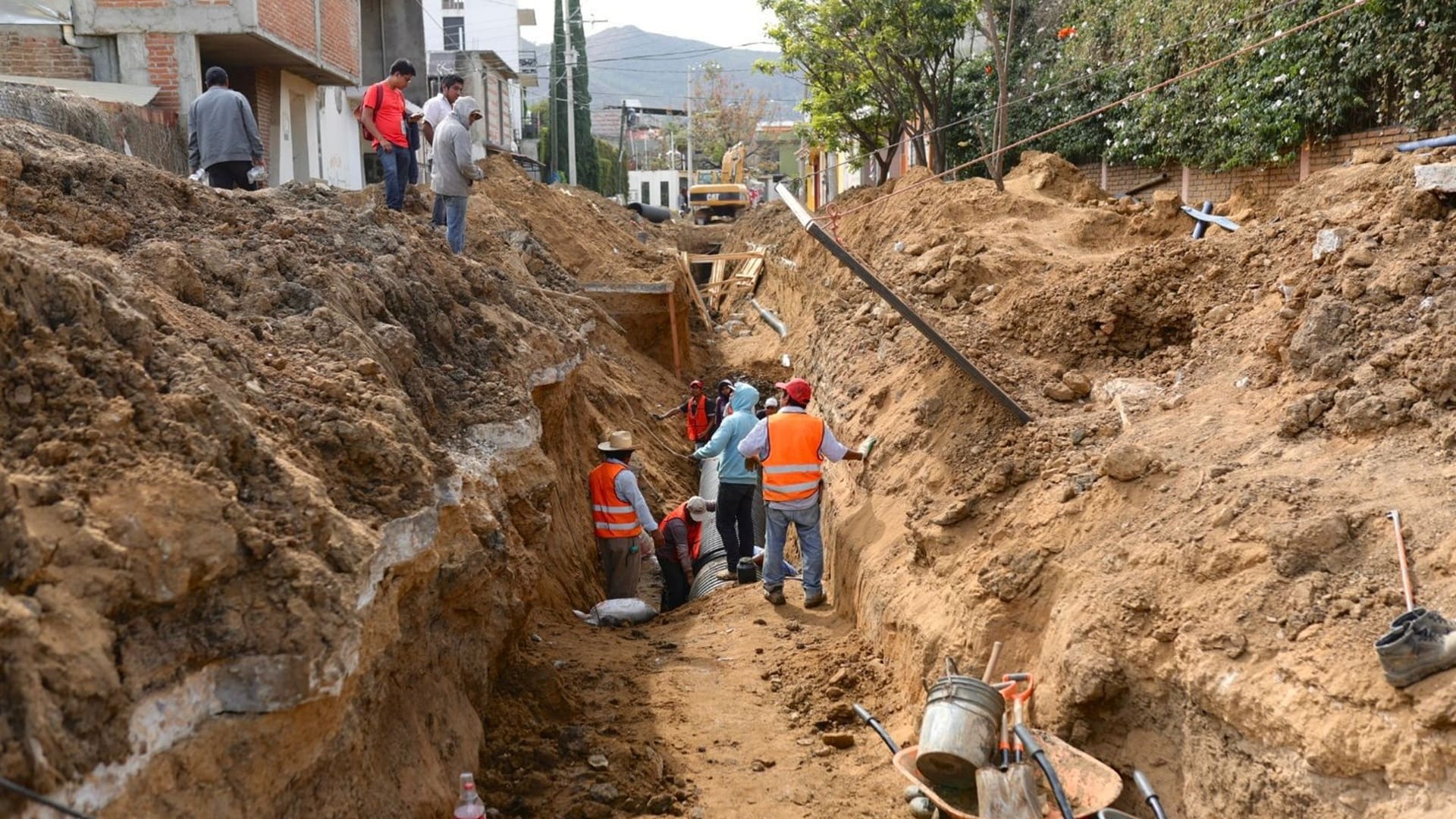 Trabajadores de Ceabien de Oaxaca laboran en una zanja profunda.