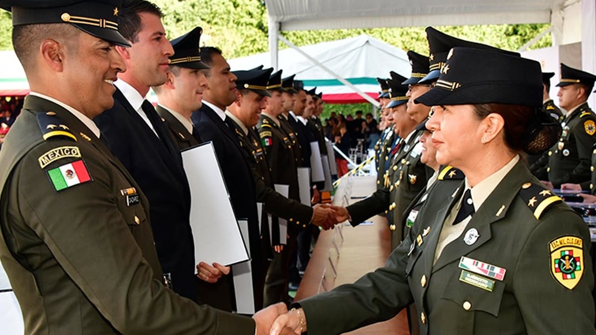 Una mujer del Ejército Mexicano saluda a otro oficial durante una ceremonia